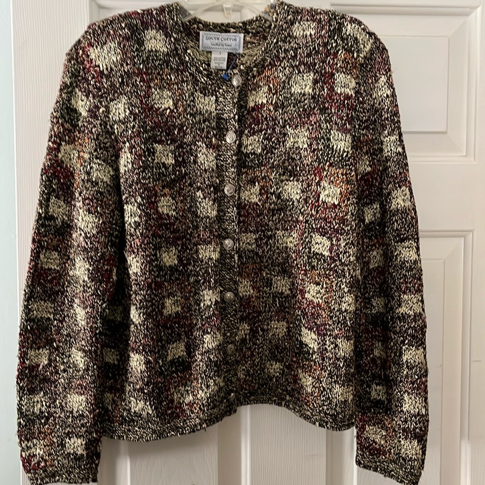 Hand knitted jacket by South Cotton. Never worn. Silver floral style buttons.